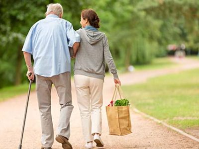 Caregiver – woman helping senior man with shopping